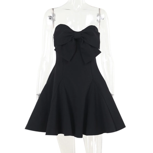 Detail of black strapless mini dress featuring a large bow and pleated A-line skirt silhouette