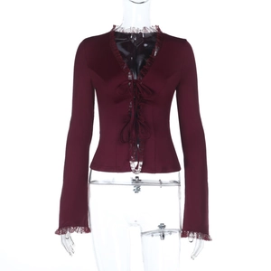 Detailed view of dark wine red chiffon top with V-neckline, lace trim and tie-up front design