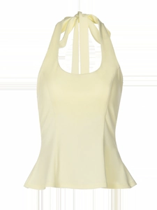 Detailed close-up of light yellow halter top with peplum hem and back tie-up design