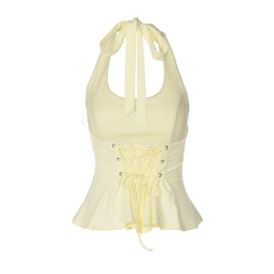 Detail of light yellow halter top featuring corset lace-up waist and peplum hemline