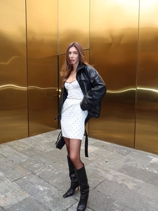 Vue détaillée du blouson en cuir noir avec robe à pois et bottes pointues au-dessus du genou
