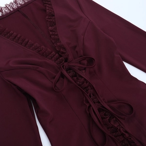 Detail of burgundy V-neck chiffon top with ruffled lace trim and criss-cross front tie