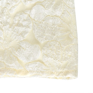 Detailed macro view of ivory jacquard fabric with elegant floral textured patterns