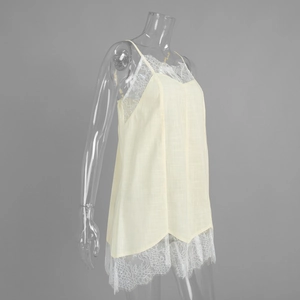 Detail view of the fine white eyelash lace trim and light yellow textured fabric