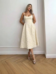 Elegant cream off-shoulder midi dress with floral jacquard texture and flared A-line skirt