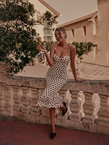 Elegant white polka dot dress with sweetheart neckline and ruffled hem for summer parties