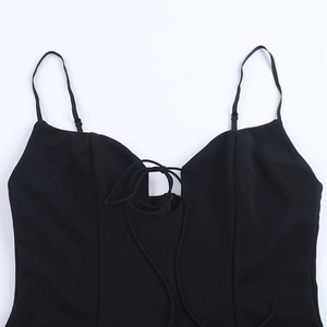 Détail des bretelles réglables et du décolleté en V à cordon sur une mini robe noire sexy