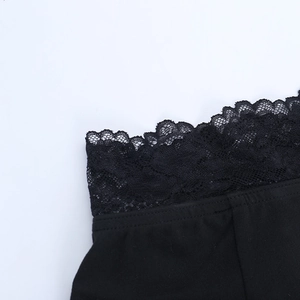 Close-up of black lace trim and fine needlework on a slim-fit off-shoulder top