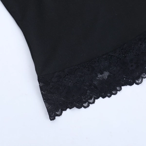 Close-up of intricate black lace trim and smooth fabric on an off-shoulder top