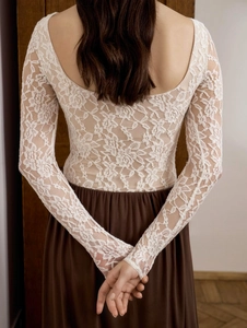 Detailed back view of white floral lace slim fit top with elegant U-shaped open back design