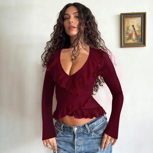 Detail view of ruffled V-neckline and tie-waist on this vintage dark red long sleeve top
