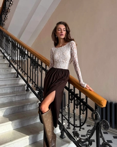 Detailed view of women's white floral lace long sleeve top and side slit maxi skirt