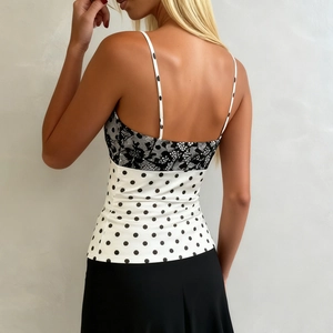 Rear view of women's satin polka dot camisole with black floral lace stitching and open back