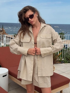 Beige cotton linen two-piece set featuring loose long sleeve shirt and wide-leg shorts