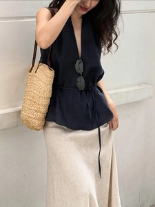 Elegant navy blue V-neck halter top with drawstring waist and beige linen skirt