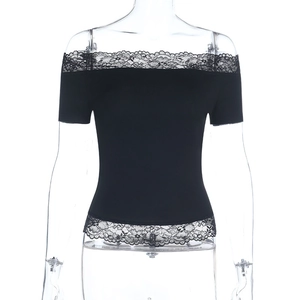 Detail of delicate black lace trim on the neckline and hem of the off-shoulder top