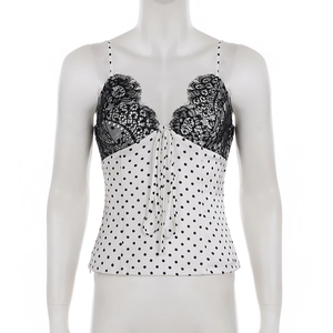 Detail of V-neck lace trim and polka dot satin fabric on a women camisole top