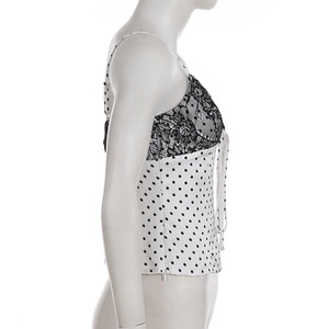 Detail view of lace trim and side invisible zipper on a polka dot satin camisole top