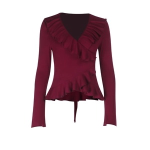 Detail of wine red wrap top showing ruffle edges and plunging V-neckline fabric texture