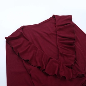 Close-up of wine red V-neckline with decorative flounce ruffles on retro long sleeve top
