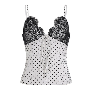 Detailed view of black lace trim and polka dot satin fabric on a women's camisole top