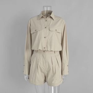 Close-up of beige cotton shirt and pleated shorts set with clear fabric texture detail