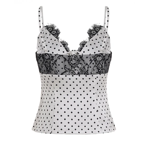 Close-up of white satin camisole featuring black polka dots and delicate eyelash lace trim