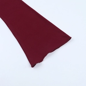 Detailed close-up of dark wine red knitted bell sleeves with ruffle edge stitching