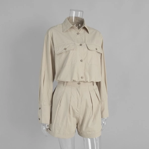 Detail view of khaki cotton shirt set with flap pockets and pleated cuffed shorts