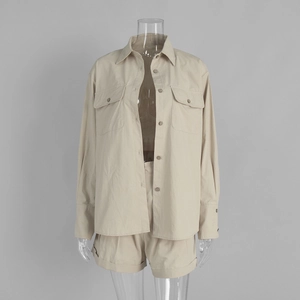 Detail of cotton long-sleeve shirt with flap pockets and matching cuffed shorts