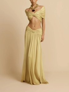 Detail of light green two-piece set featuring a ruched crop top and matching maxi skirt