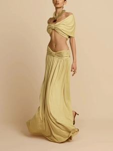 Detail of elegant two-piece set featuring a pleated off-shoulder crop top and long skirt