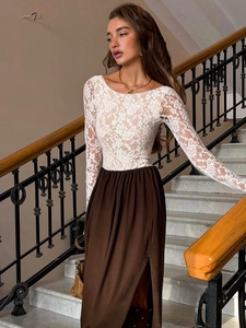 Elegant white lace long sleeve top and brown high slit maxi skirt on a classic staircase