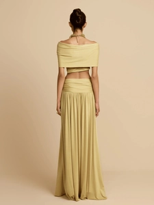Elegant back view of light yellow two-piece set with off-shoulder crop top and pleated skirt