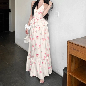 Detail of floral halter top with ruffled peplum and matching high-waisted maxi skirt