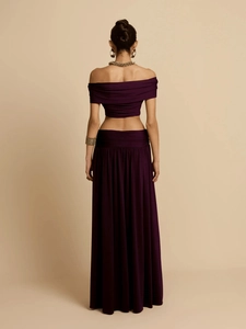 Elegant deep purple two-piece set featuring off-shoulder crop top and high-waist maxi skirt
