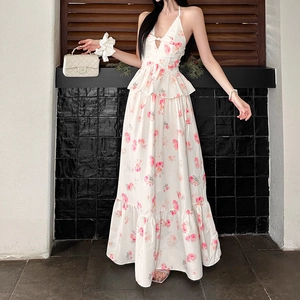 Detail of floral halter maxi dress featuring V-neck cutout and pink rose patterns