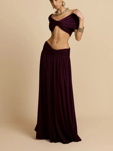 Detail of plum purple two-piece set featuring off-shoulder twist top and pleated maxi skirt
