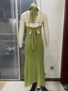 Detail of green halter neck dress showing large backless design with a chiffon bow tie