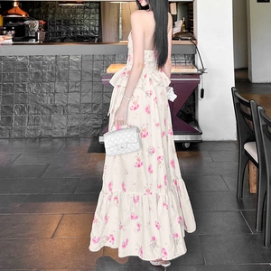 Detail of floral backless halter maxi dress featuring multi-layer ruffled skirt and pink flowers