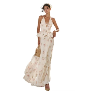 Detailed macro view of the halter neck tie and floral bow design on this two-piece summer dress
