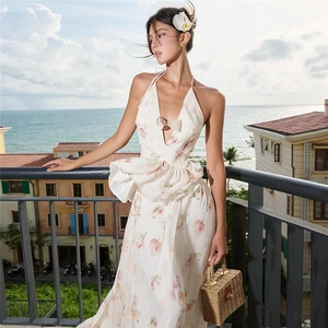 Detailed halter neck floral maxi dress with bow accent and cascading ruffles for resort wear