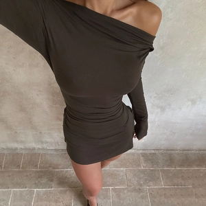 Detail of slim fit off-shoulder mini dress in dark olive green with long sleeves