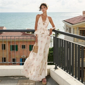 Detail view of a floral two-piece vacation set featuring a halter top and tiered maxi skirt