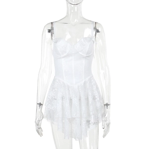 Detail of white lace corset dress featuring underwire cups and tiered ruffle hemline