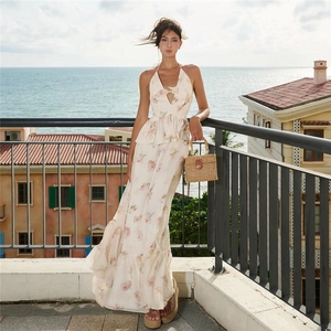 Detail of floral halter maxi dress with cutout front and ruffled chiffon hemline