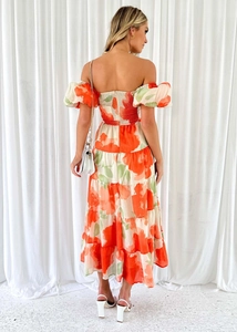 Detail of tiered floral mini dress with smocked back and bubble sleeves in orange print