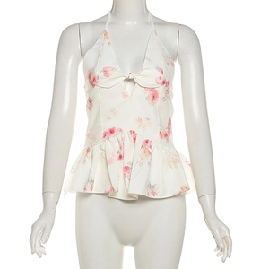 Close-up of halter neck floral top with bow knot detail and ruffle peplum hem