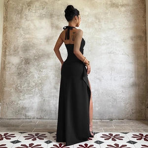 Detail of the backless halter neck design and high side slit on this elegant black dress
