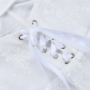 Close-up of white lace dress featuring intricate floral patterns and ribbon lace-up detail